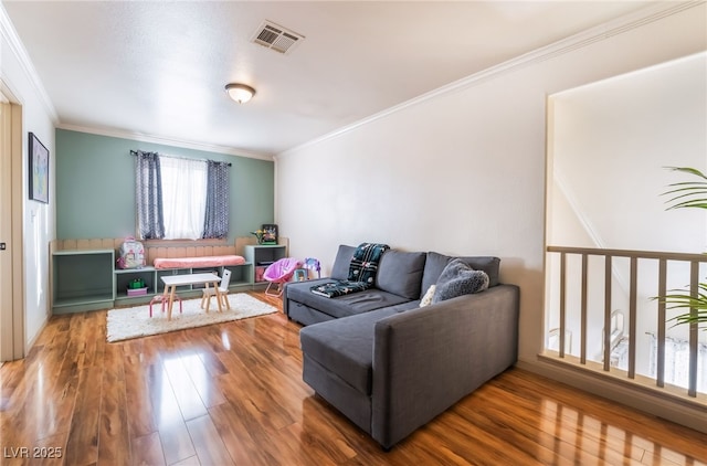 living room with crown molding and wood-type flooring