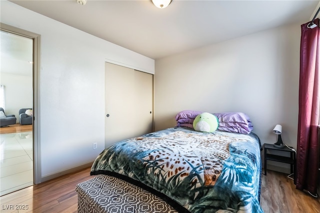 bedroom with hardwood / wood-style flooring and a closet