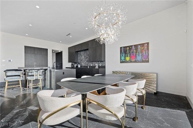 dining area with a chandelier, recessed lighting, marble finish floor, and baseboards