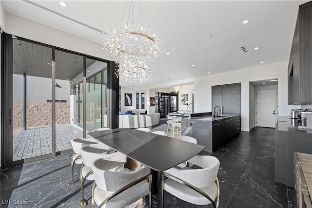 dining room with marble finish floor, recessed lighting, and an inviting chandelier