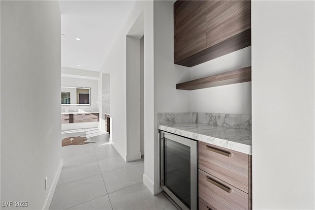 bar with light tile patterned floors, wine cooler, baseboards, and recessed lighting