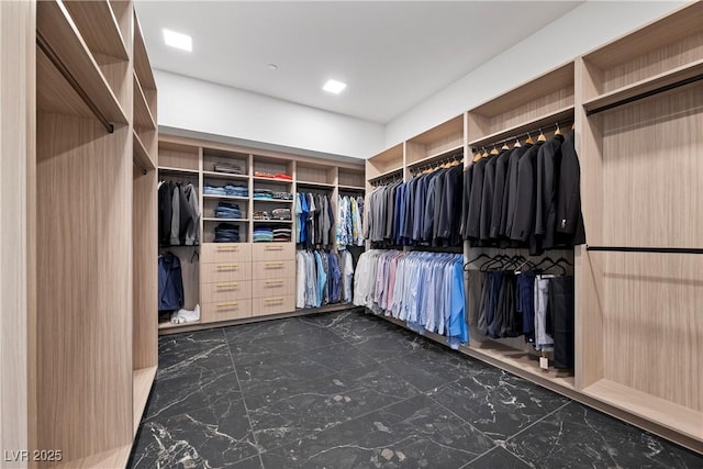 spacious closet with marble finish floor