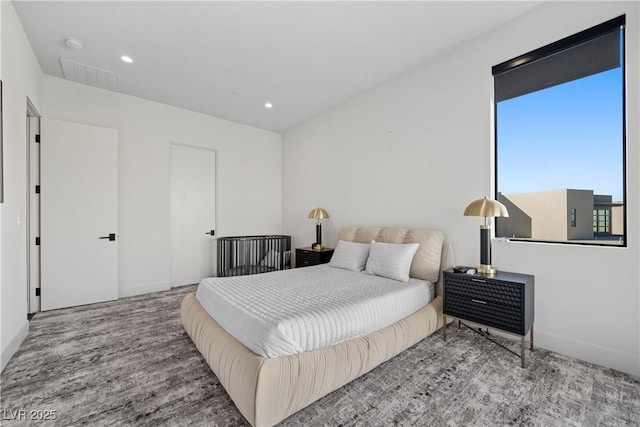 bedroom with baseboards, visible vents, wood finished floors, and recessed lighting