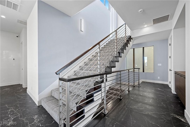 stairs featuring marble finish floor, baseboards, visible vents, and recessed lighting