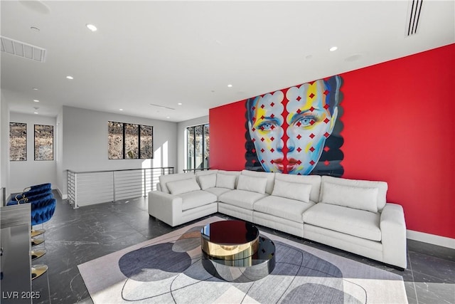 living area featuring an accent wall, recessed lighting, visible vents, and baseboards