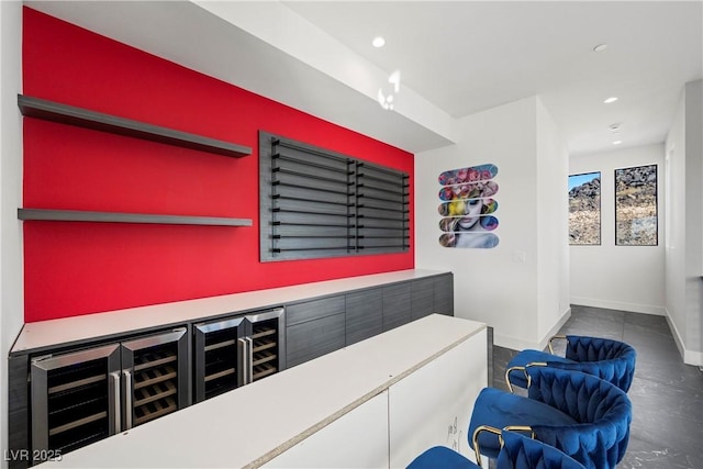 bar with a dry bar, baseboards, and recessed lighting