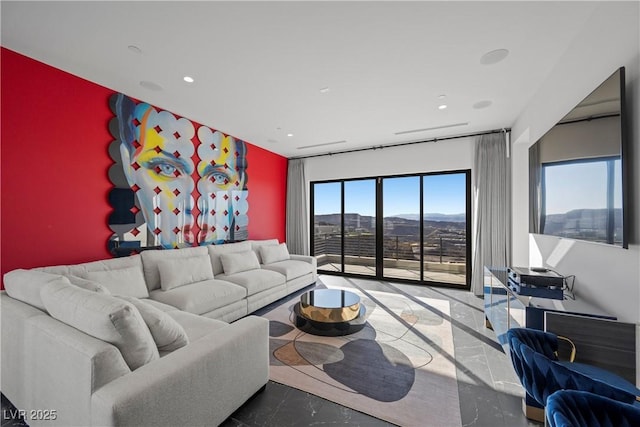 living room featuring an accent wall, a wealth of natural light, and recessed lighting