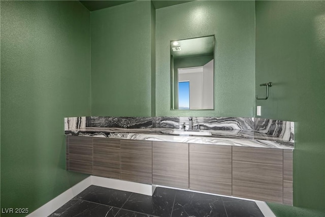 bathroom with marble finish floor, visible vents, vanity, and baseboards