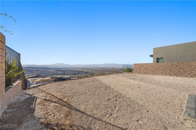 view of yard with fence and a mountain view