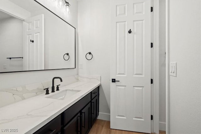 bathroom with hardwood / wood-style flooring and vanity