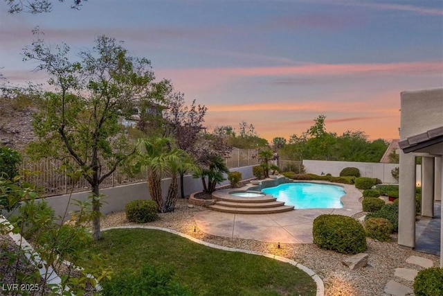 pool at dusk with a patio