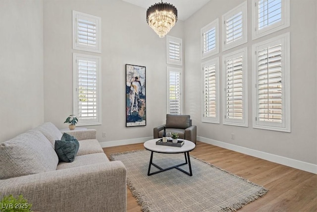 living area featuring hardwood / wood-style flooring and a chandelier