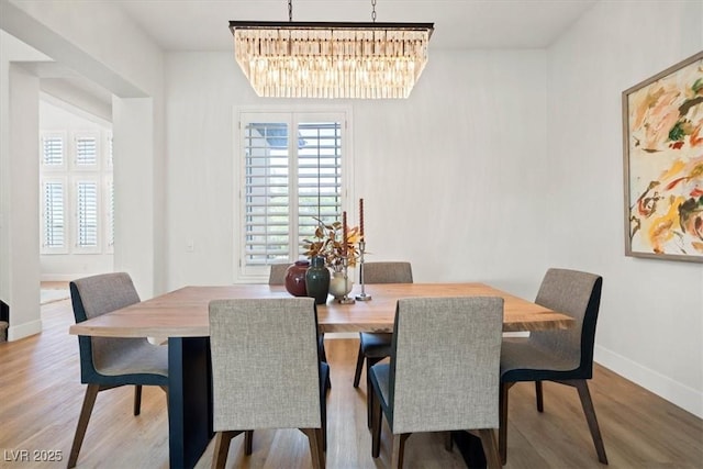 dining space featuring an inviting chandelier and hardwood / wood-style floors