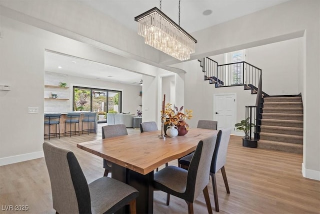 dining space with a chandelier and light wood-type flooring