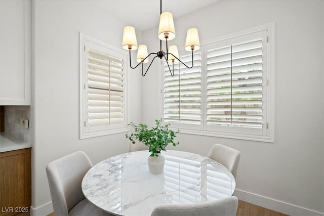 dining area with an inviting chandelier and hardwood / wood-style floors