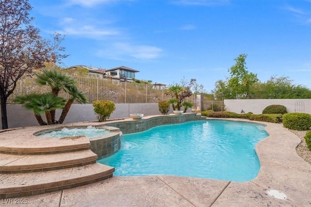 view of swimming pool with pool water feature and an in ground hot tub