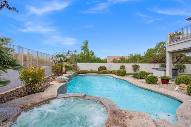 view of swimming pool with an in ground hot tub