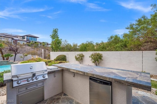 view of patio with area for grilling and a grill