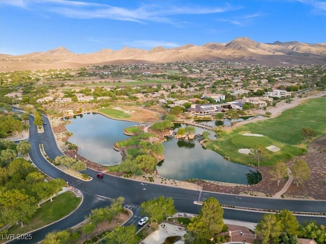 birds eye view of property with a water and mountain view