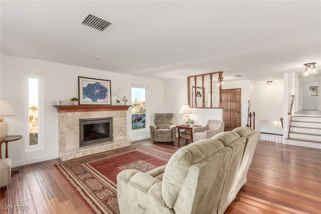 living room with hardwood / wood-style floors and a high end fireplace