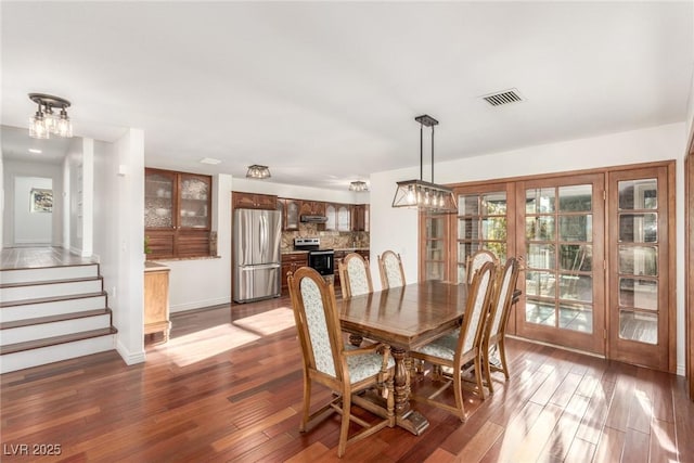 dining space featuring dark wood-type flooring and french doors