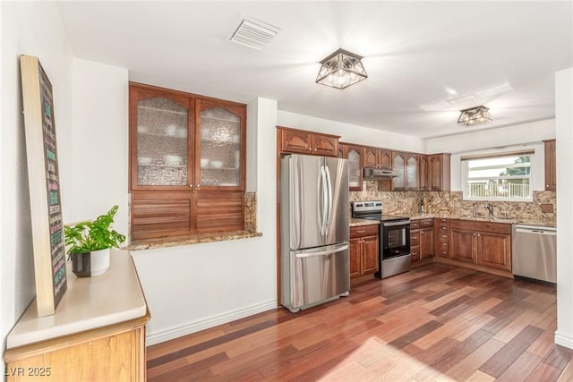 kitchen featuring backsplash, sink, dark hardwood / wood-style floors, and appliances with stainless steel finishes