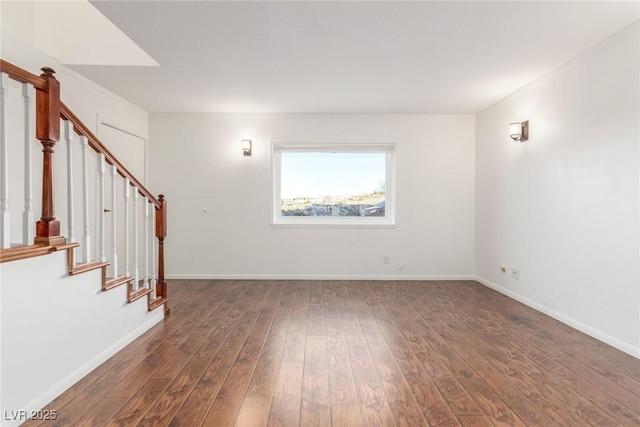 unfurnished room with ornamental molding and dark hardwood / wood-style floors