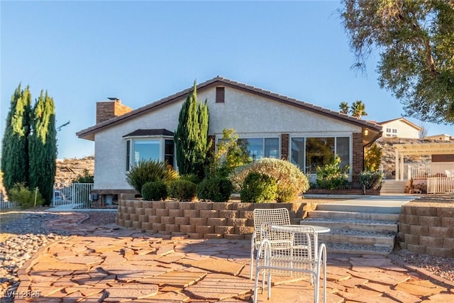 back of property featuring a patio area