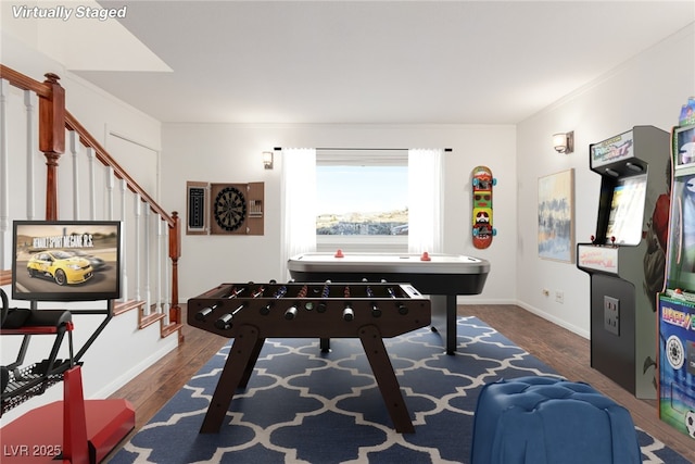 rec room featuring crown molding and dark wood-type flooring