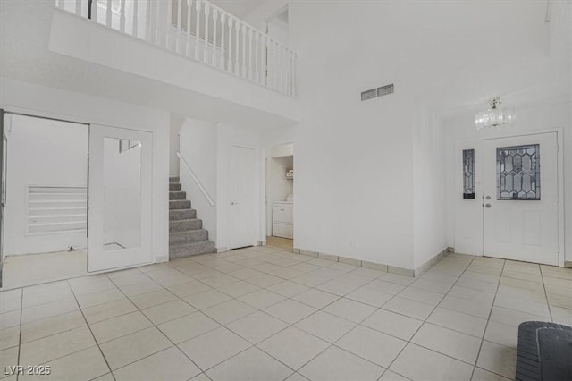 interior space featuring an inviting chandelier and a towering ceiling