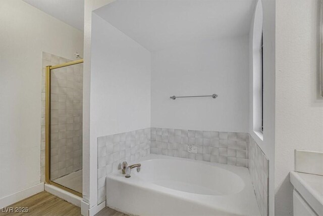 bathroom with hardwood / wood-style flooring and plus walk in shower