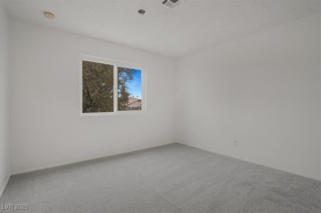 unfurnished room featuring carpet flooring and a textured ceiling