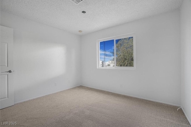 spare room featuring a textured ceiling and carpet