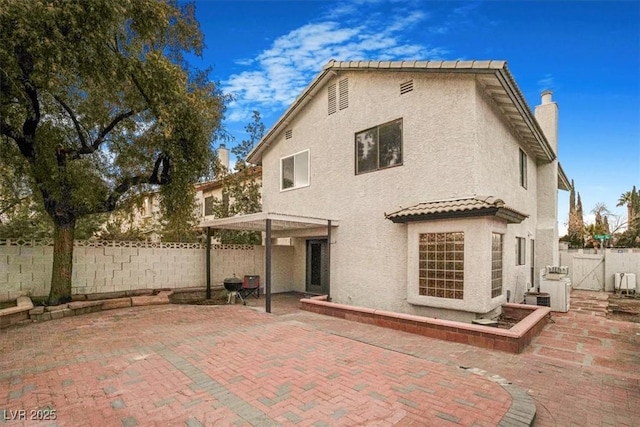 rear view of house with a pergola and a patio area