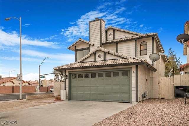 view of front of home featuring a garage and central AC