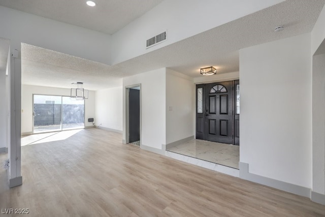 entryway featuring a textured ceiling and light wood-type flooring