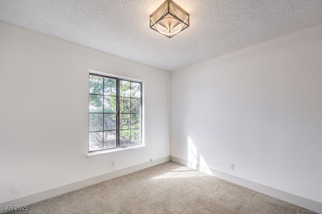 carpeted spare room with a textured ceiling