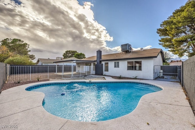 view of swimming pool featuring cooling unit and a patio