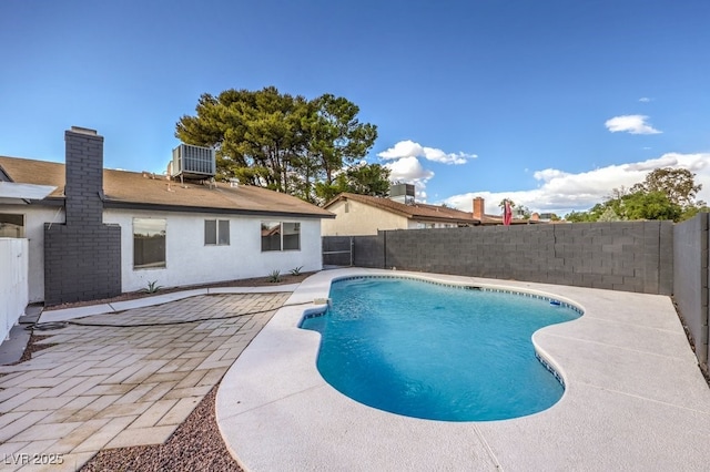 view of pool featuring a patio and central air condition unit