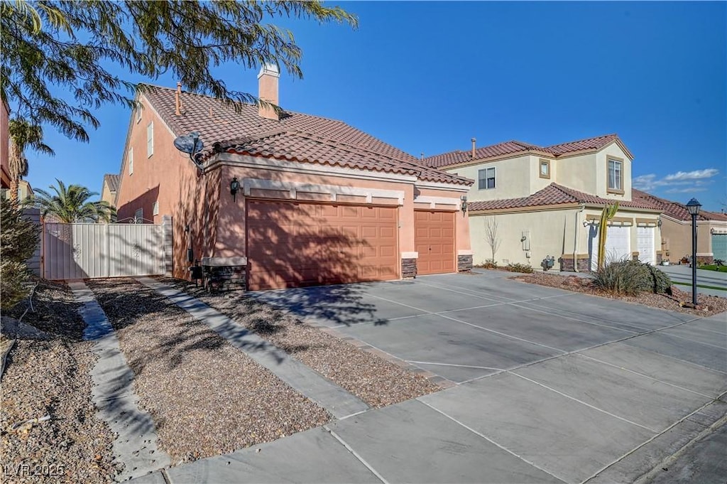 mediterranean / spanish house with a garage