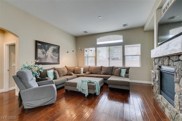 living room featuring dark hardwood / wood-style floors and a fireplace