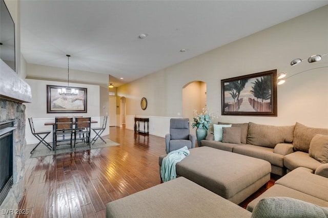 living room featuring dark wood-type flooring and a fireplace