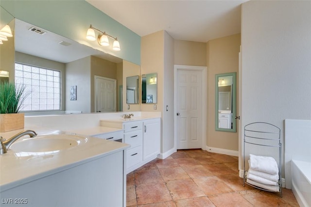 bathroom with a washtub and vanity