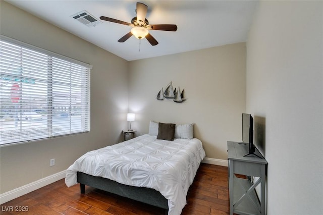 bedroom with dark hardwood / wood-style floors and ceiling fan