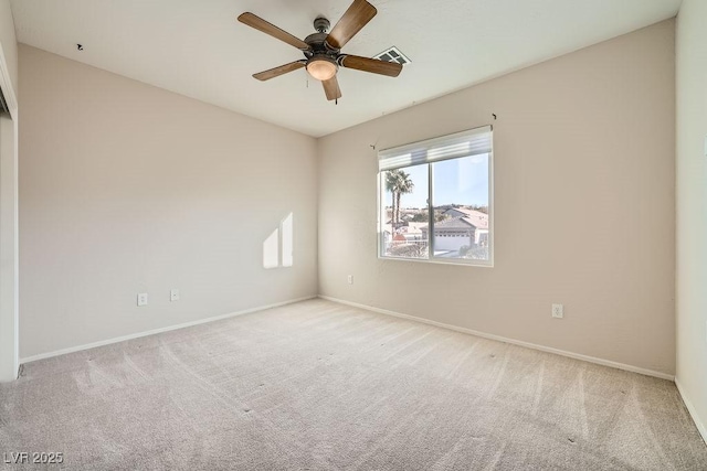 empty room featuring light colored carpet and ceiling fan