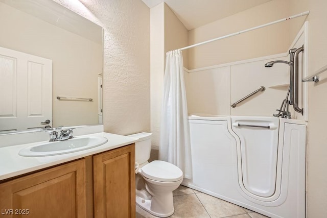 bathroom with tile patterned floors, vanity, and toilet