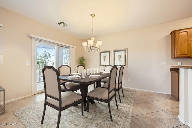 dining area featuring a notable chandelier and light tile patterned floors