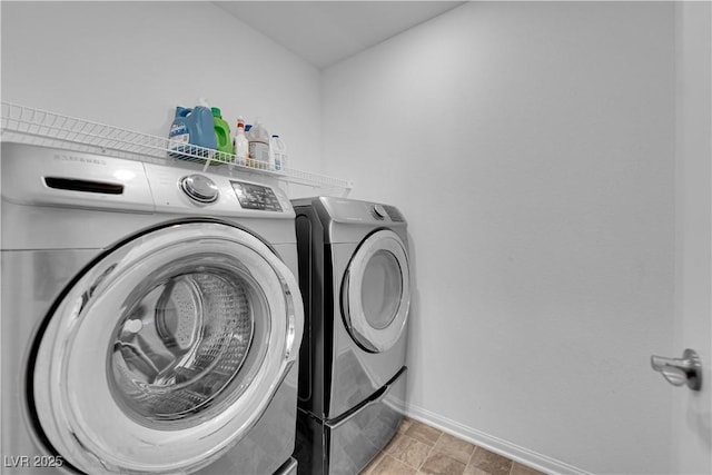 clothes washing area featuring washing machine and clothes dryer