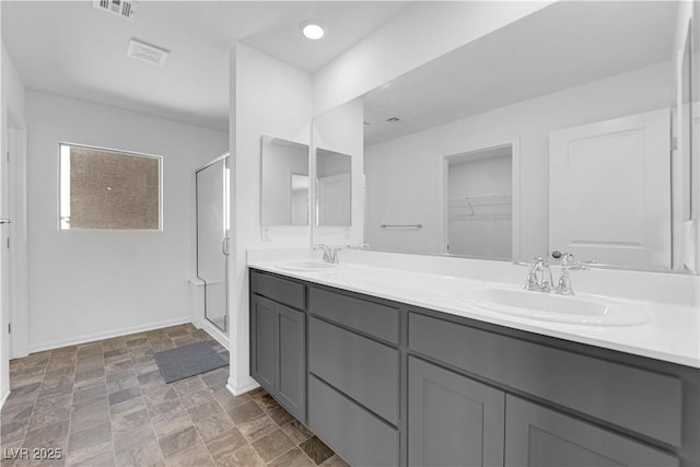 bathroom featuring vanity and a shower with shower door