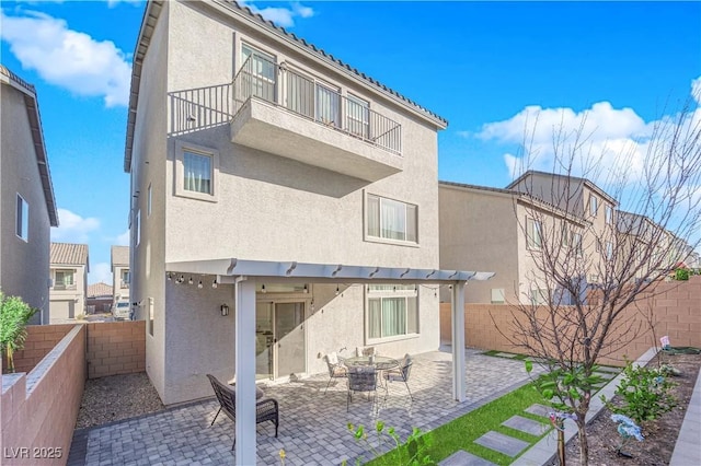 back of house featuring a patio and a balcony